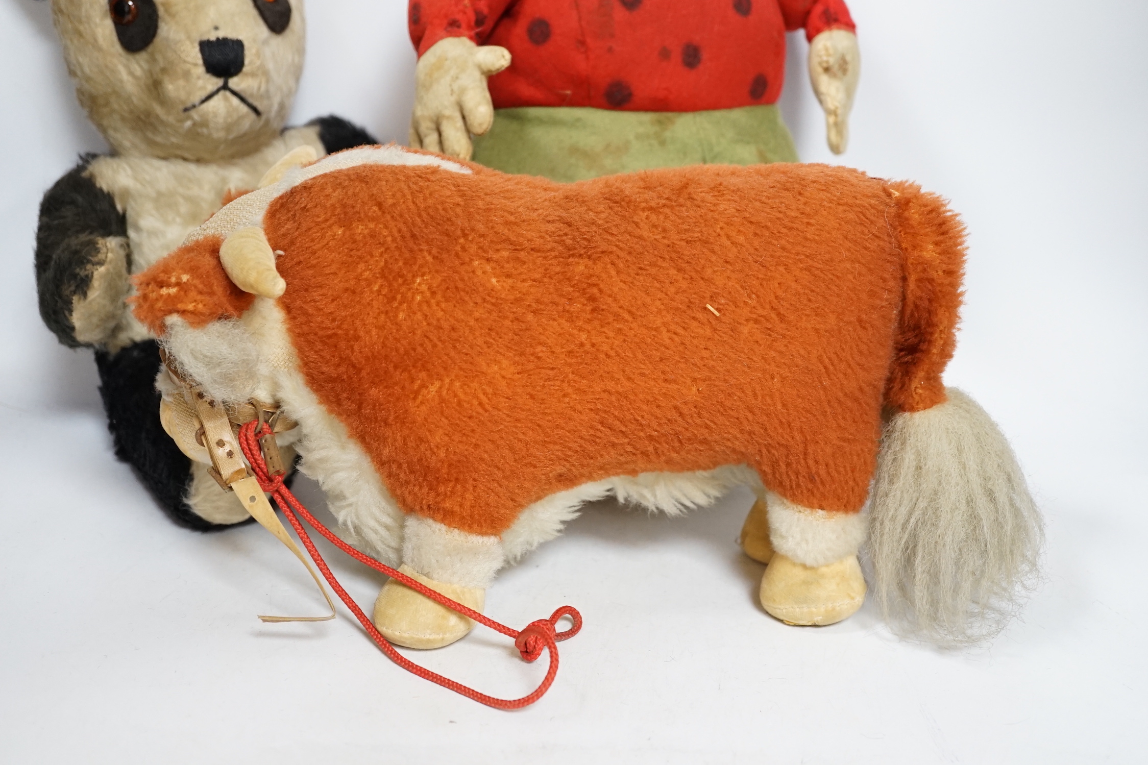 A Katzenjammer Kids 'Misses', felt body and composition face, 36cm high, a Chiltern panda, 1950's, and a Merrythought bull, 1950's (hair loss)